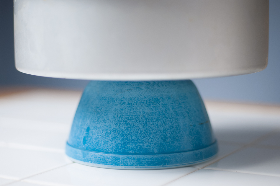 9" Fat Daddio on top of inverted blue bowl.  Ready to push down and reveal the lemon lemon tart cheesecake