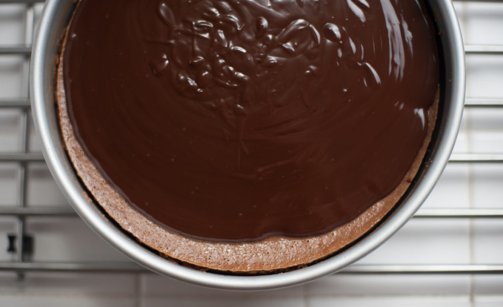 chocolate to the 4th power cheesecake on IKEA cooling rack covered with chocolate ganache