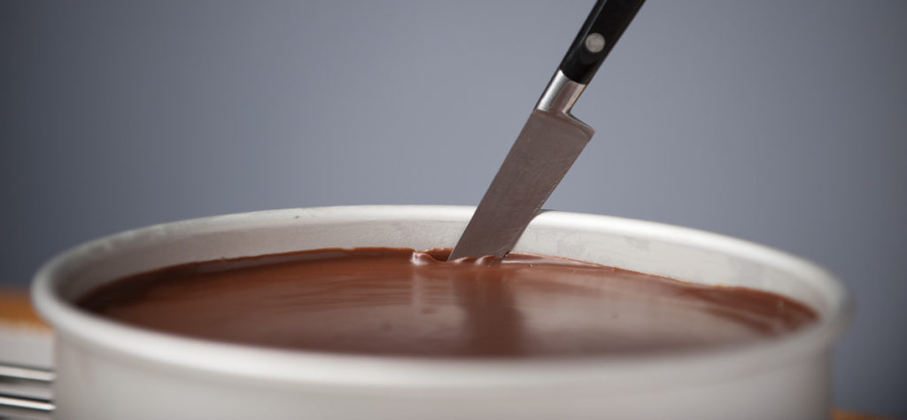 run a thin sharp knife around the edge of the 9" Fat Daddio to loosen the chocolate ganache layer from the wall of the pan