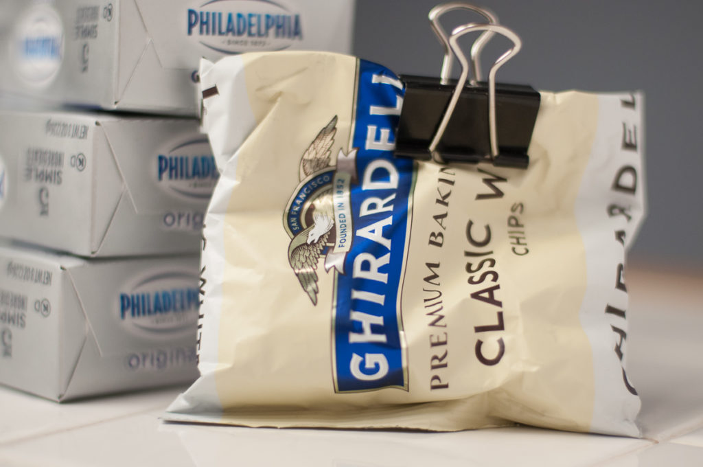 bricks of Philadelphia cream cheese and package of Ghirardelli white chocolate chips