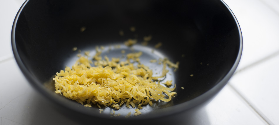Black bowl with lemon zest ready to go into lemon curd