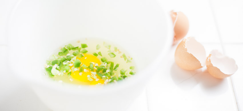 EGGS AND DICED JALAPENOS READY FOR WHISKING